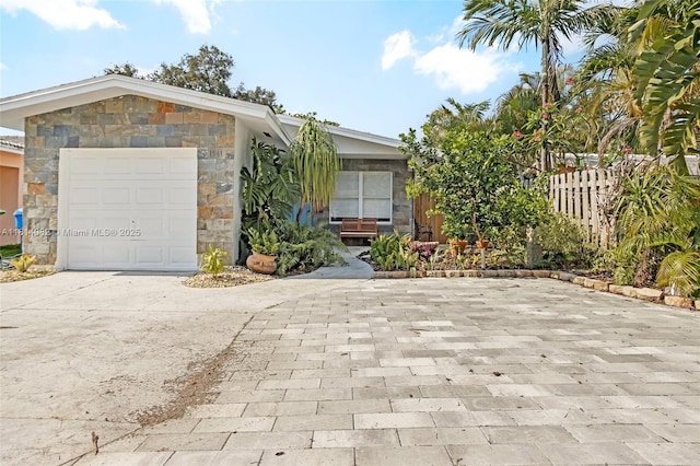 1547 NE 38th St, Oakland Park, FL 33334 - view of front of house featuring stone siding and concrete driveway