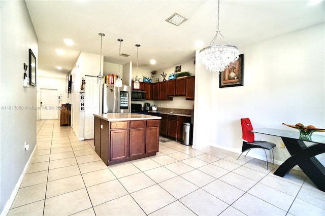 18972 SW 318th Ter, Homestead, FL 33030 - kitchen with stainless steel appliances, light tile patterned floors, a chandelier, light countertops, and pendant lighting