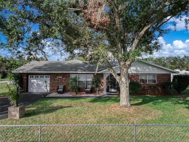 2430 N Dunwoodie Rd, Avon Park, FL 33825 - ranch-style home featuring a garage, brick siding, and asphalt driveway