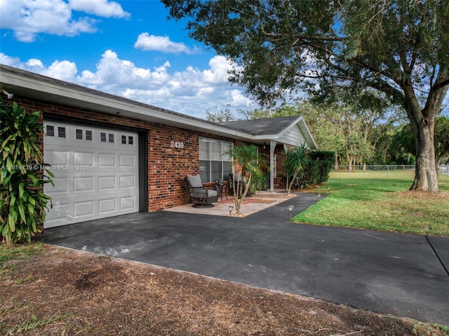 2430 N Dunwoodie Rd, Avon Park, FL 33825 - view of front of property with brick siding, asphalt driveway, and an attached garage