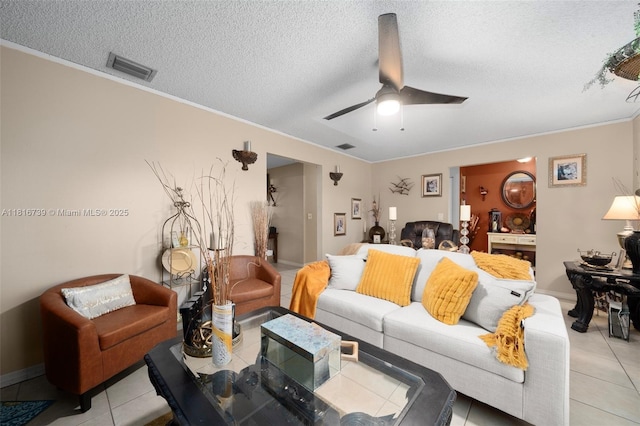 2430 N Dunwoodie Rd, Avon Park, FL 33825 - living area featuring light tile patterned floors, a textured ceiling, ceiling fan, and crown molding