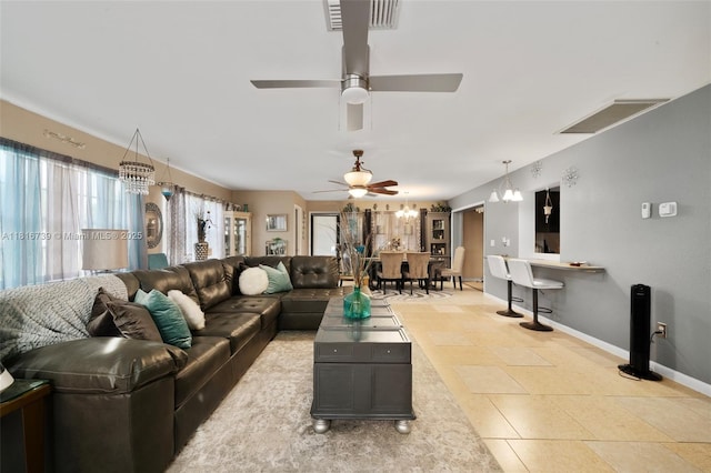 2430 N Dunwoodie Rd, Avon Park, FL 33825 - living room with ceiling fan, a chandelier, and light tile patterned flooring