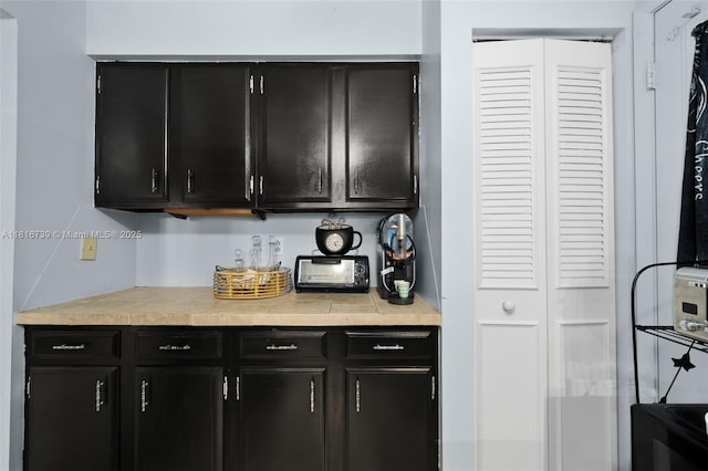 2430 N Dunwoodie Rd, Avon Park, FL 33825 - kitchen featuring dark cabinets and light countertops