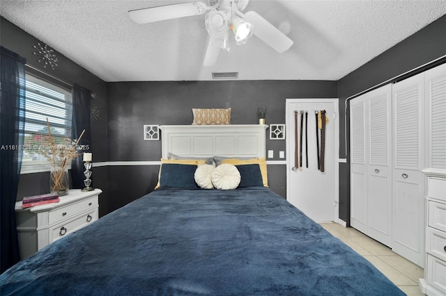 2430 N Dunwoodie Rd, Avon Park, FL 33825 - bedroom featuring light tile patterned floors, a textured ceiling, and a ceiling fan