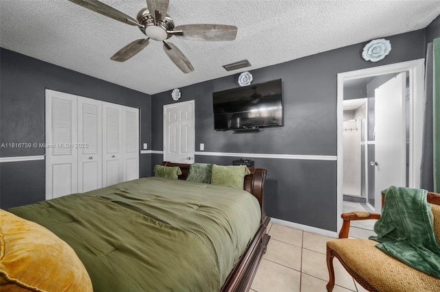 2430 N Dunwoodie Rd, Avon Park, FL 33825 - bedroom with light tile patterned flooring, a closet, a textured ceiling, and a ceiling fan