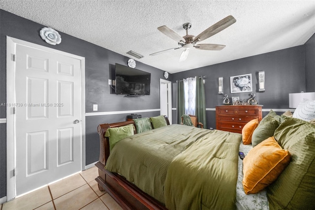 2430 N Dunwoodie Rd, Avon Park, FL 33825 - tiled bedroom featuring a textured ceiling and a ceiling fan