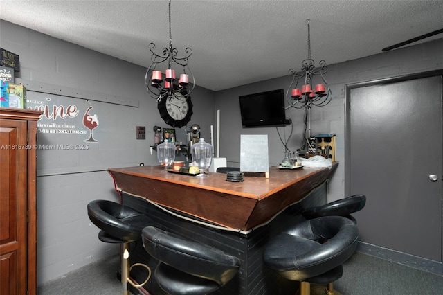 2430 N Dunwoodie Rd, Avon Park, FL 33825 - indoor dry bar with a chandelier, a textured ceiling, and carpet flooring