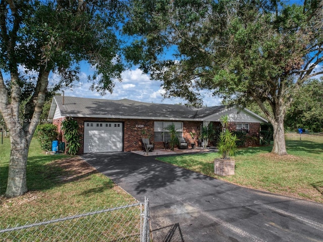 2430 N Dunwoodie Rd, Avon Park, FL 33825 - ranch-style house featuring an attached garage, asphalt driveway, and brick siding