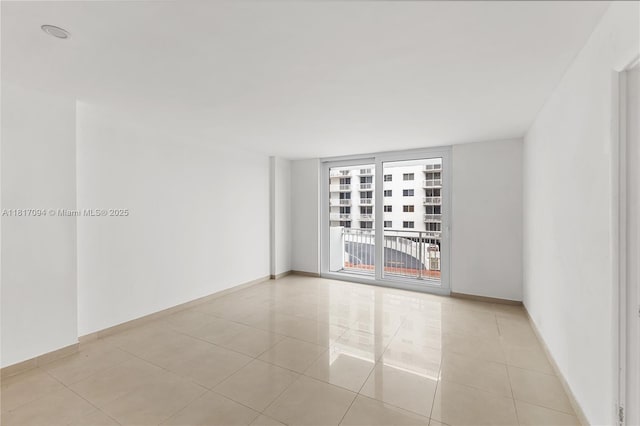 345 Ocean Dr Unit 321, Miami Beach, FL 33139 - spare room featuring light tile patterned flooring and baseboards