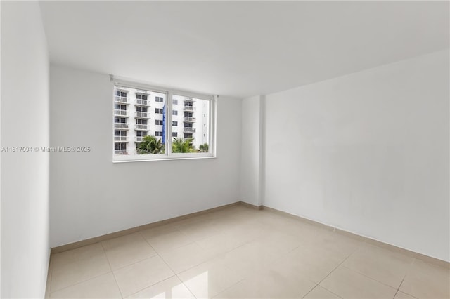 345 Ocean Dr Unit 321, Miami Beach, FL 33139 - spare room with baseboards and light tile patterned flooring