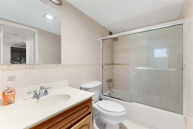 345 Ocean Dr Unit 321, Miami Beach, FL 33139 - bathroom featuring tile walls, vanity, enclosed tub / shower combo, tile patterned floors, and backsplash