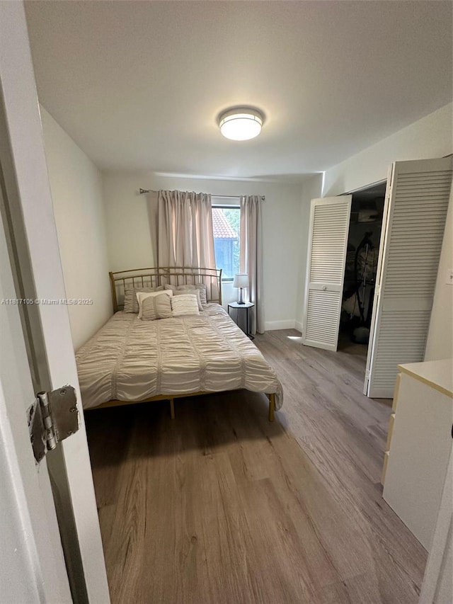 12 Via De Casas Sur Unit 104, Boynton Beach, FL 33426 - bedroom featuring wood finished floors and baseboards