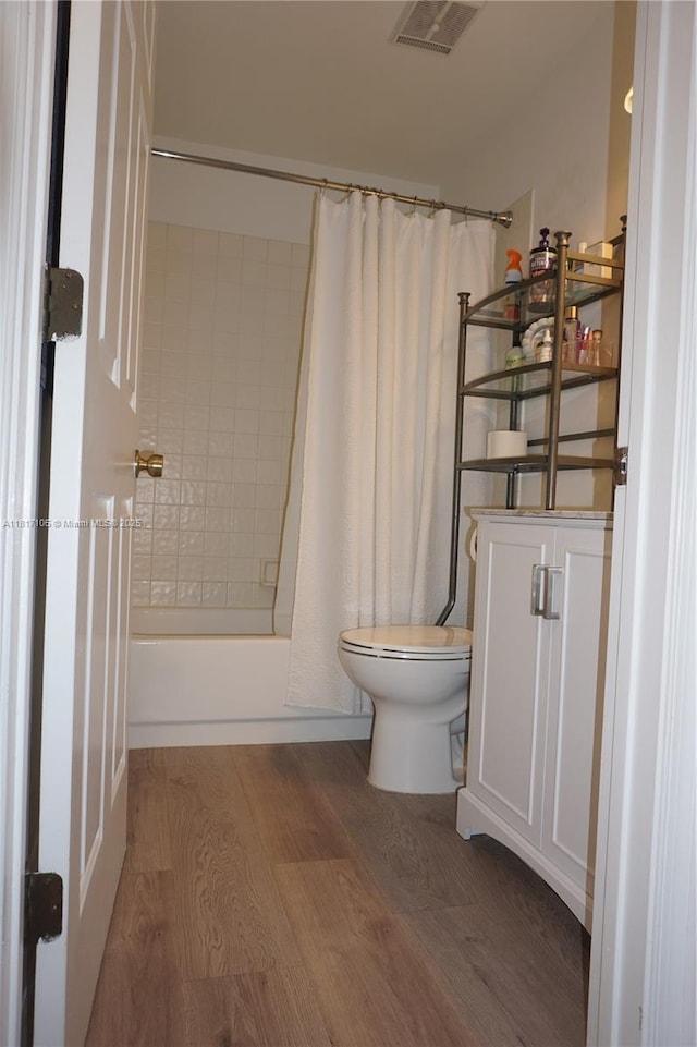 12 Via De Casas Sur Unit 104, Boynton Beach, FL 33426 - full bathroom with toilet, shower / tub combo, wood finished floors, and vanity