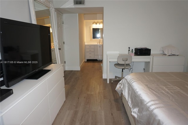 12 Via De Casas Sur Unit 104, Boynton Beach, FL 33426 - bedroom featuring wood finished floors and ensuite bathroom
