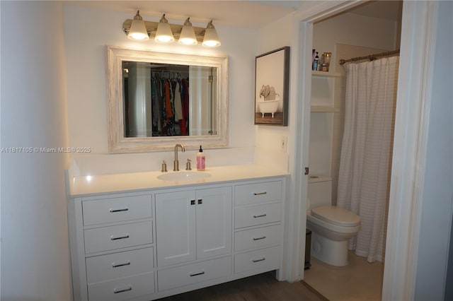 12 Via De Casas Sur Unit 104, Boynton Beach, FL 33426 - full bathroom featuring toilet, vanity, and a shower with shower curtain