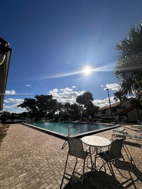 12 Via De Casas Sur Unit 104, Boynton Beach, FL 33426 - swimming pool with a patio