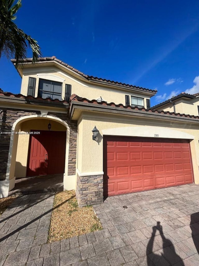 3385 W 86th Ter, Hialeah, FL 33018 - mediterranean / spanish-style home with stone siding, stucco siding, and a tile roof