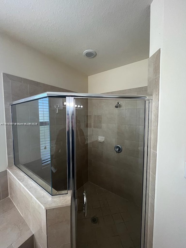 3385 W 86th Ter, Hialeah, FL 33018 - full bath featuring a stall shower, a textured ceiling, and tile patterned floors