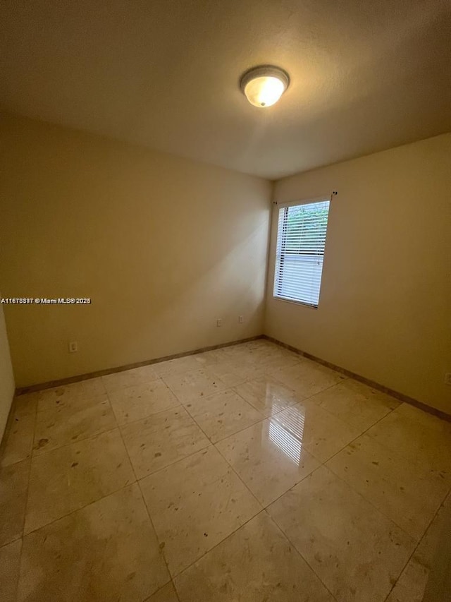 3385 W 86th Ter, Hialeah, FL 33018 - spare room featuring baseboards and light tile patterned floors
