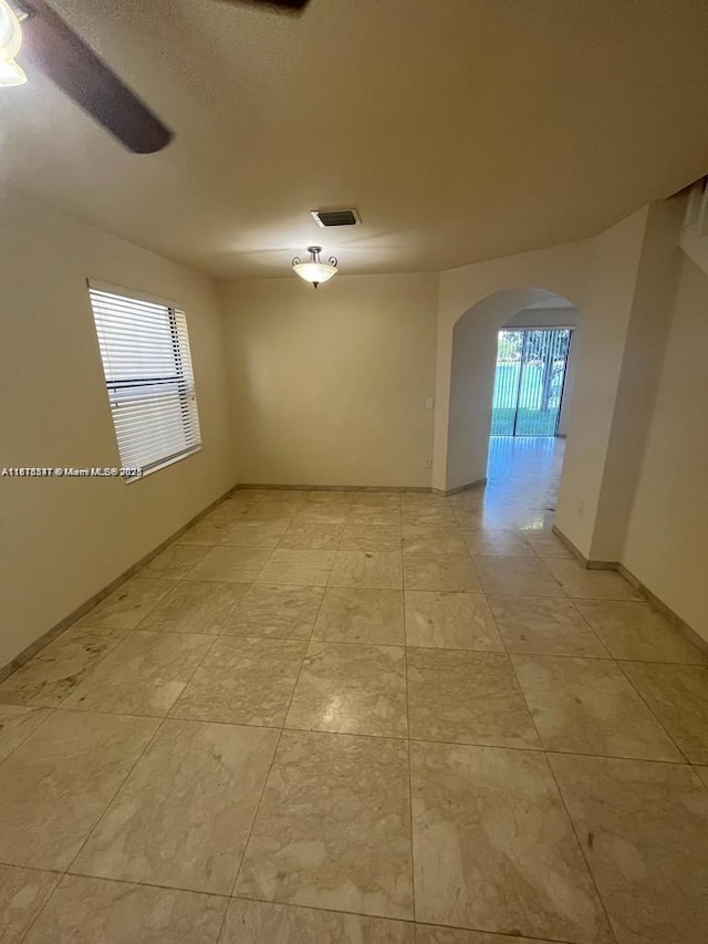 3385 W 86th Ter, Hialeah, FL 33018 - spare room with arched walkways and baseboards