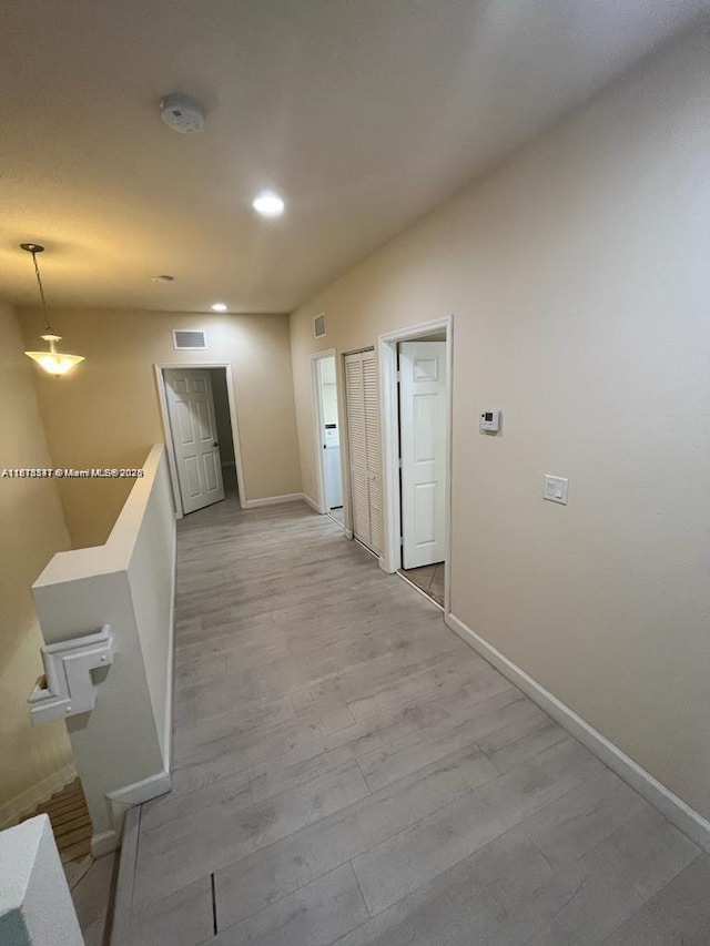 3385 W 86th Ter, Hialeah, FL 33018 - corridor featuring baseboards, recessed lighting, light wood finished floors, and an upstairs landing