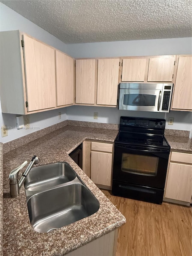 3705SW 27 Th St Unit 416, Gainesville, FL 32608 - kitchen featuring stainless steel microwave, black electric range oven, light brown cabinetry, and a textured ceiling