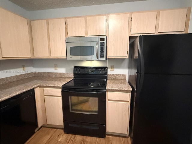 3705SW 27 Th St Unit 416, Gainesville, FL 32608 - kitchen featuring black appliances, light wood-style floors, light countertops, and light brown cabinetry
