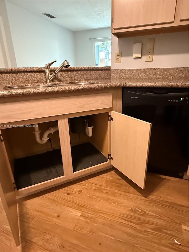 3705SW 27 Th St Unit 416, Gainesville, FL 32608 - detailed view of black dishwasher, a sink, and wood finished floors