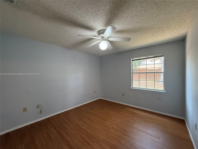 3705SW 27 Th St Unit 416, Gainesville, FL 32608 - spare room featuring a ceiling fan, wood finished floors, a textured ceiling, and baseboards