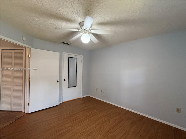 3705SW 27 Th St Unit 416, Gainesville, FL 32608 - unfurnished bedroom with wood finished floors, a textured ceiling, baseboards, and a ceiling fan
