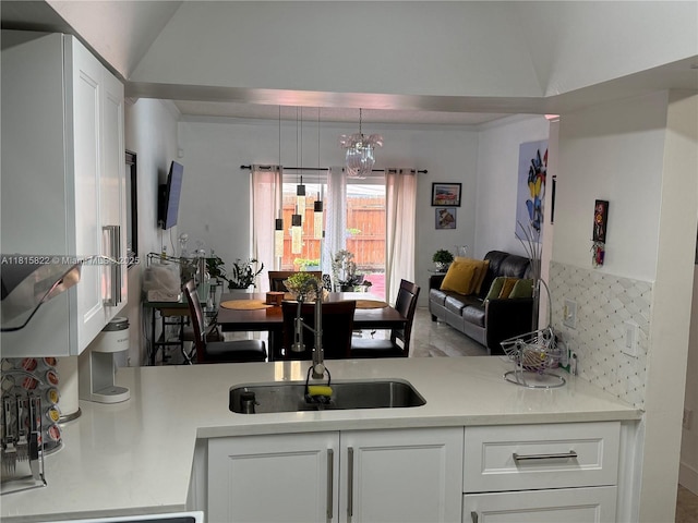 6560 SW 138th Ct Unit 804, Miami, FL 33183 - kitchen with a chandelier, light countertops, white cabinets, and vaulted ceiling