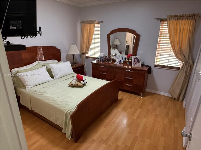 6560 SW 138th Ct Unit 804, Miami, FL 33183 - bedroom featuring light wood finished floors, arched walkways, and ornamental molding