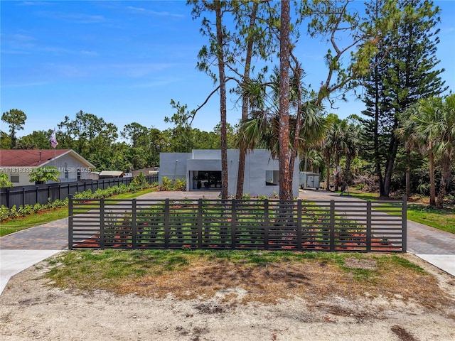 1902 Della Dr, Naples, FL 34117 - contemporary house with a fenced front yard and stucco siding