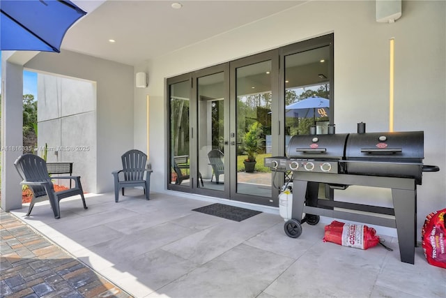 1902 Della Dr, Naples, FL 34117 - property entrance featuring french doors, stucco siding, and a patio