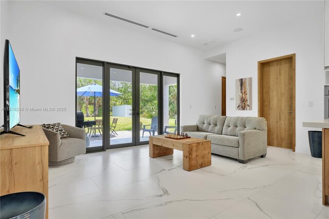 1902 Della Dr, Naples, FL 34117 - living room with french doors, recessed lighting, light marble finish floors, and a towering ceiling
