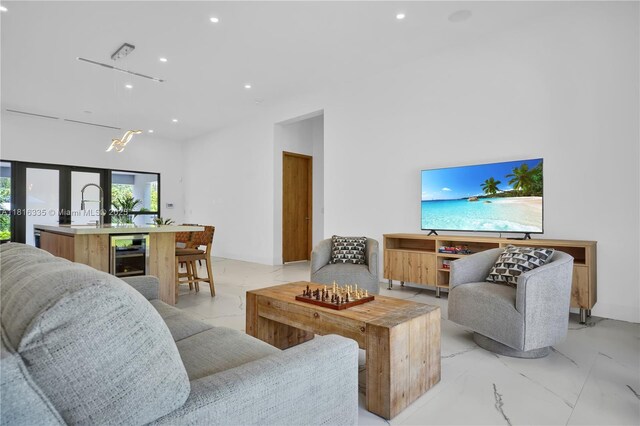 1902 Della Dr, Naples, FL 34117 - living area featuring beverage cooler, recessed lighting, and light marble finish flooring