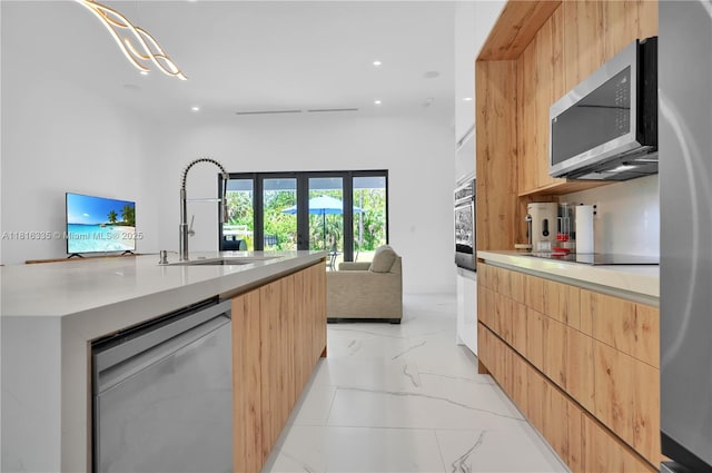 1902 Della Dr, Naples, FL 34117 - kitchen featuring modern cabinets, stainless steel appliances, a sink, light brown cabinetry, and recessed lighting