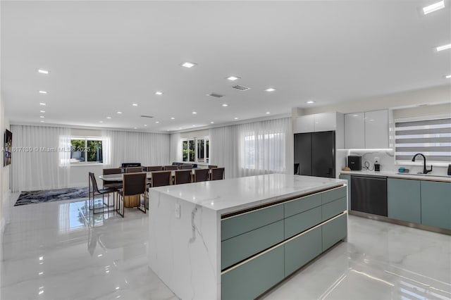 1045 Hollywood Blvd, Hollywood, FL 33019 - kitchen with dishwashing machine, a sink, modern cabinets, a kitchen island, and light marble finish flooring