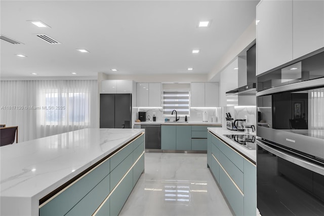 1045 Hollywood Blvd, Hollywood, FL 33019 - kitchen with modern cabinets, a sink, white cabinetry, appliances with stainless steel finishes, and wall chimney range hood
