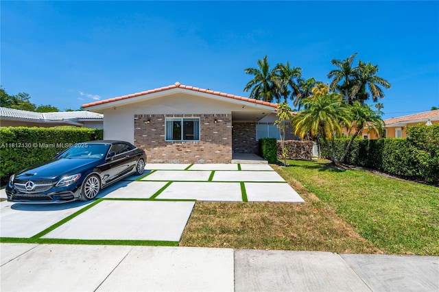 1045 Hollywood Blvd, Hollywood, FL 33019 - ranch-style house with brick siding, a front lawn, and a tiled roof