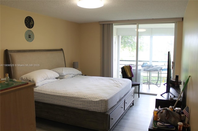 23277 N Barwood Ln N Unit 205, Boca Raton, FL 33428 - bedroom featuring access to exterior, a textured ceiling, and wood finished floors