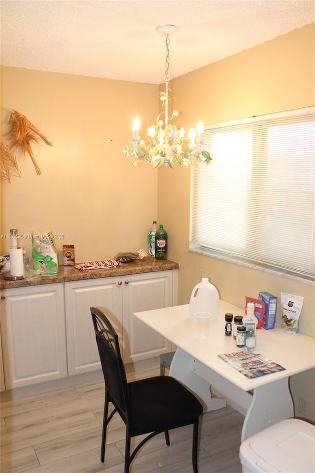 23277 N Barwood Ln N Unit 205, Boca Raton, FL 33428 - dining space with a chandelier and light wood-style flooring