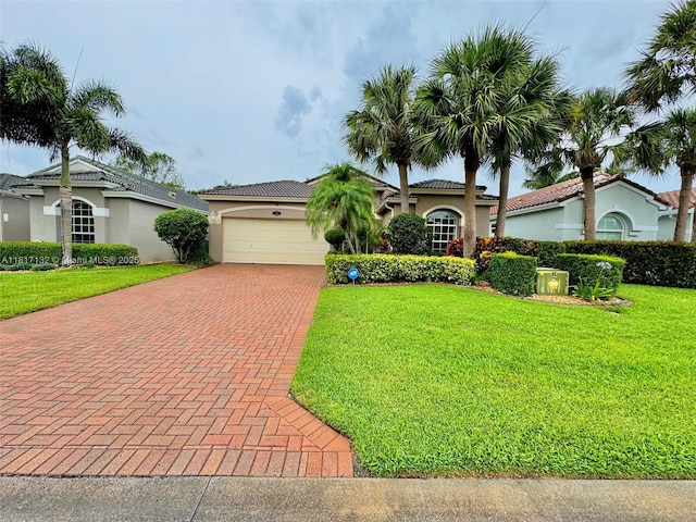 1136 SE Westminster Pl, Stuart, FL 34997 - mediterranean / spanish house featuring decorative driveway, stucco siding, a front lawn, and a garage