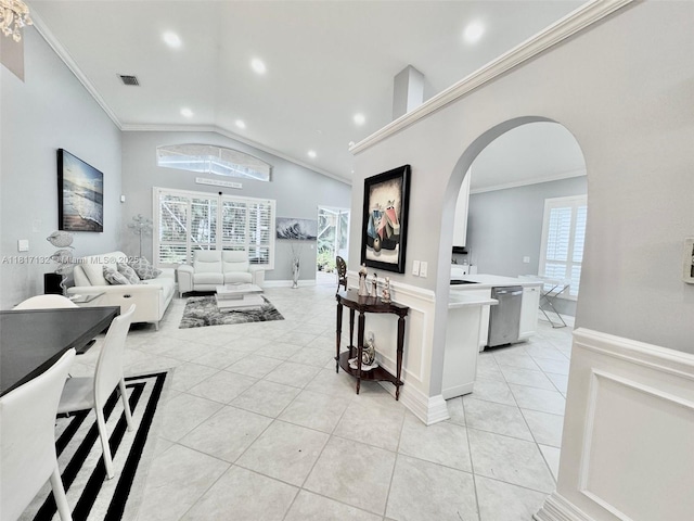 1136 SE Westminster Pl, Stuart, FL 34997 - living area featuring light tile patterned floors, arched walkways, crown molding, vaulted ceiling, and recessed lighting