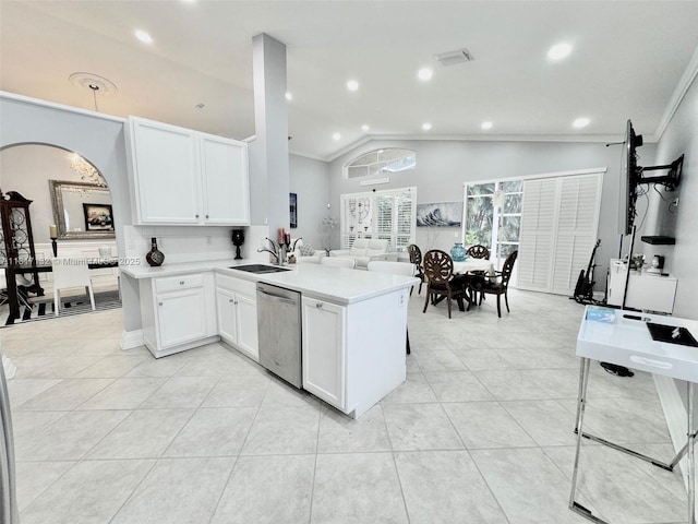 1136 SE Westminster Pl, Stuart, FL 34997 - kitchen with stainless steel dishwasher, a sink, arched walkways, light countertops, and a peninsula