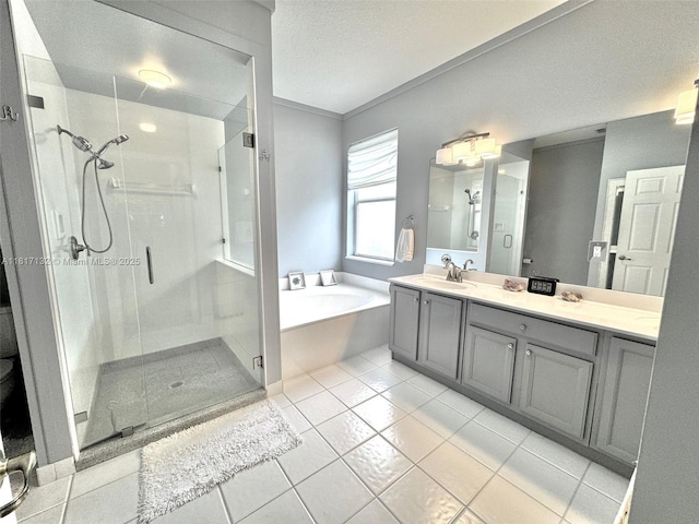 1136 SE Westminster Pl, Stuart, FL 34997 - bathroom featuring a shower stall, a garden tub, double vanity, tile patterned floors, and a textured ceiling