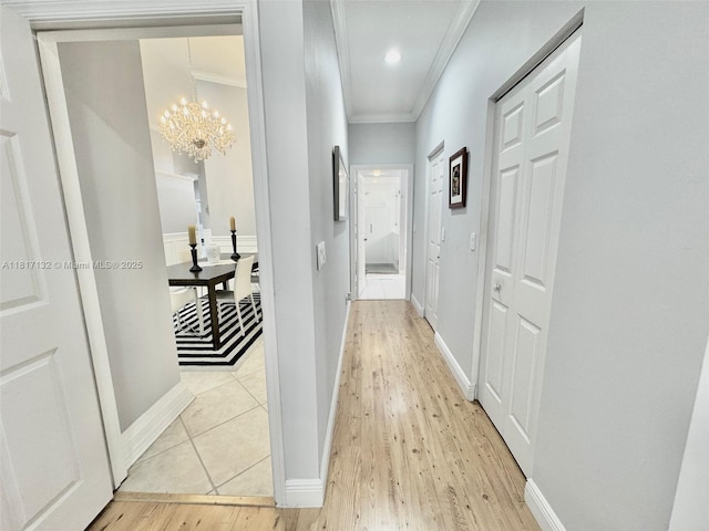 1136 SE Westminster Pl, Stuart, FL 34997 - hallway featuring ornamental molding, light wood-style floors, a chandelier, baseboards, and recessed lighting