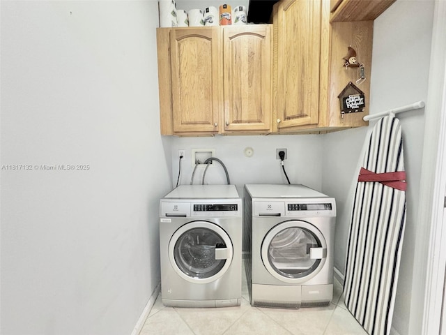 1136 SE Westminster Pl, Stuart, FL 34997 - laundry room featuring cabinet space, washer and dryer, light tile patterned flooring, and baseboards