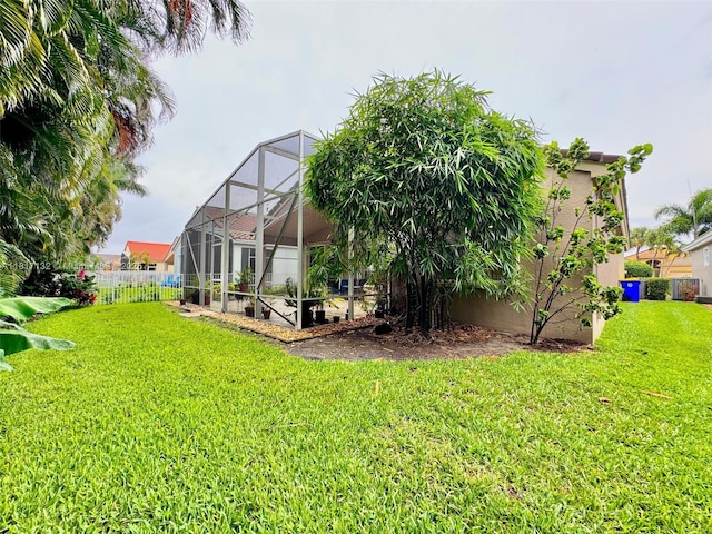 1136 SE Westminster Pl, Stuart, FL 34997 - rear view of house featuring stucco siding, a lanai, and central AC