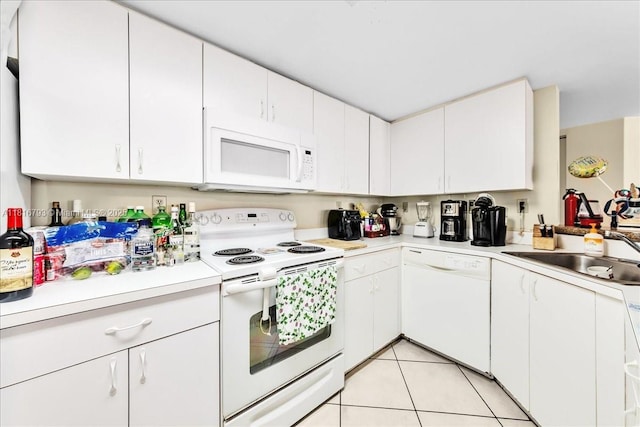 2351 Douglas Rd Unit 1204, Miami, FL 33145 - kitchen with white appliances, light countertops, white cabinets, a sink, and light tile patterned floors